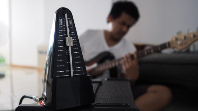 Man Playing Guitar with Metronome