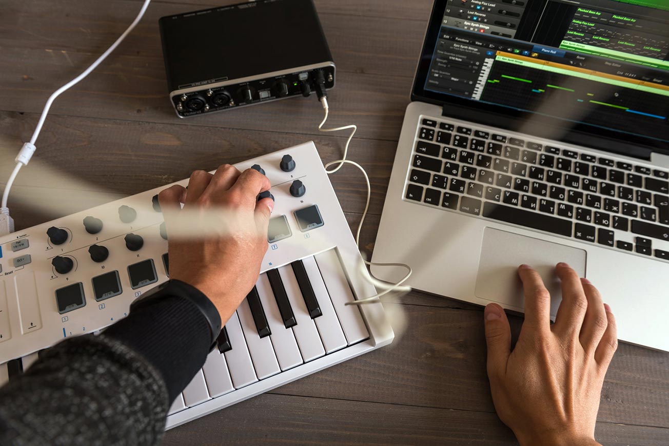 Music Producer Making Music with Midi Keyboard and Laptop - Music Program