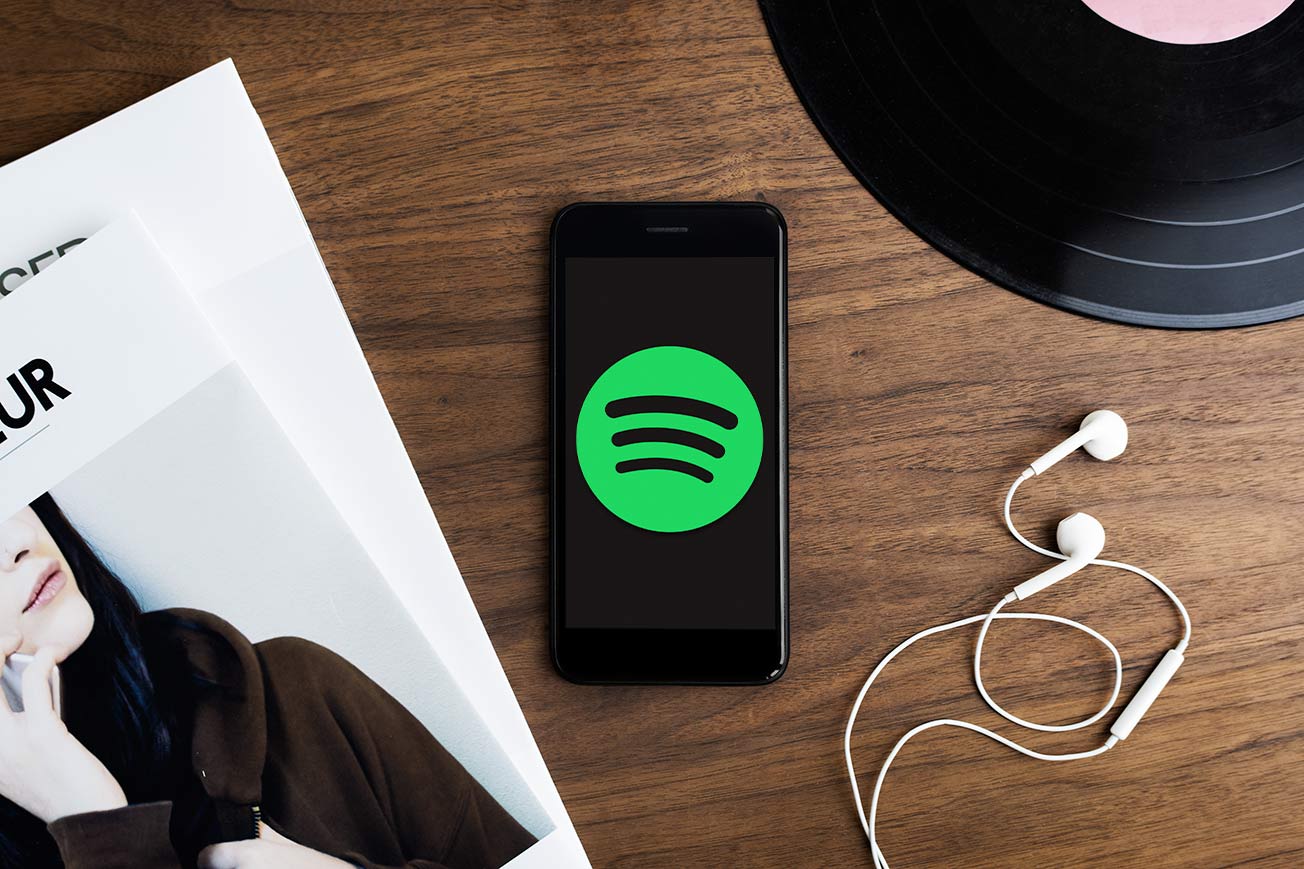 Spotify Music Streaming on Mobile Phone with Headphones and Vinyl Record